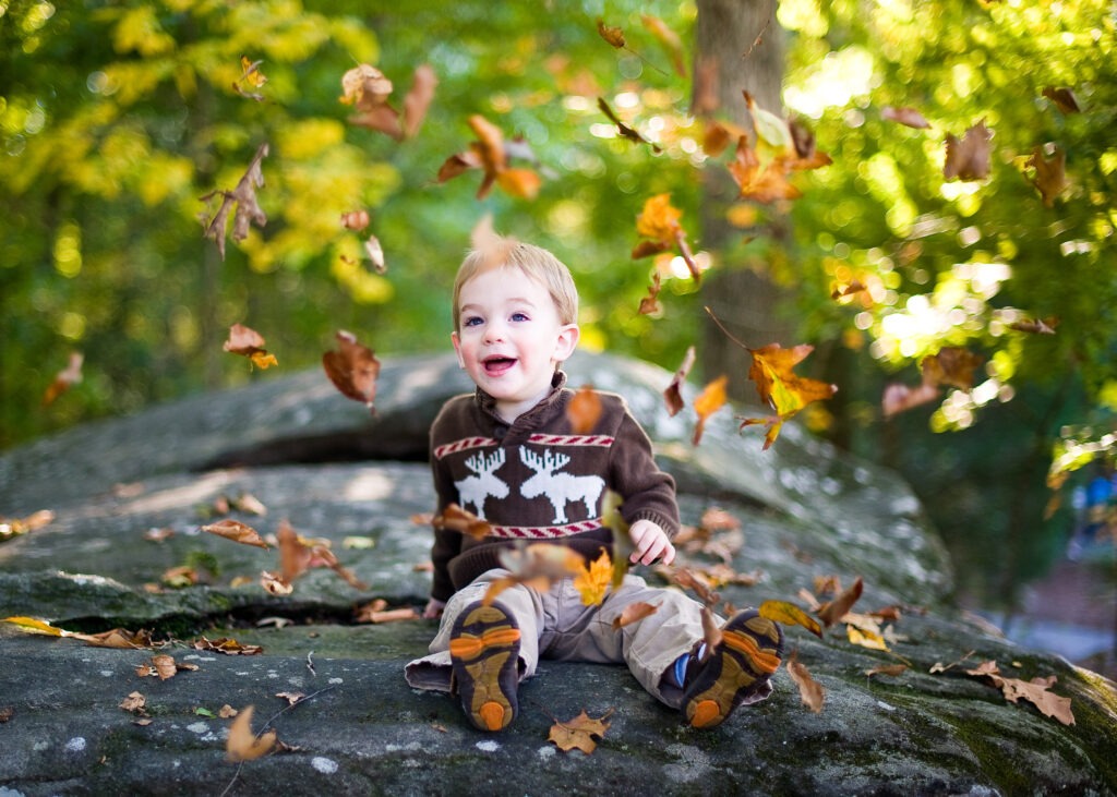 Baby boy leaves fall outdoor garden