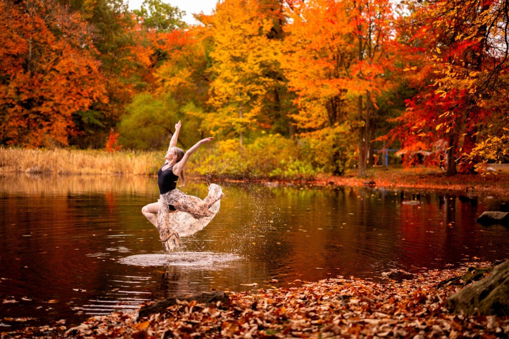 Dancer ballerina outside lake water autumn fall scenic