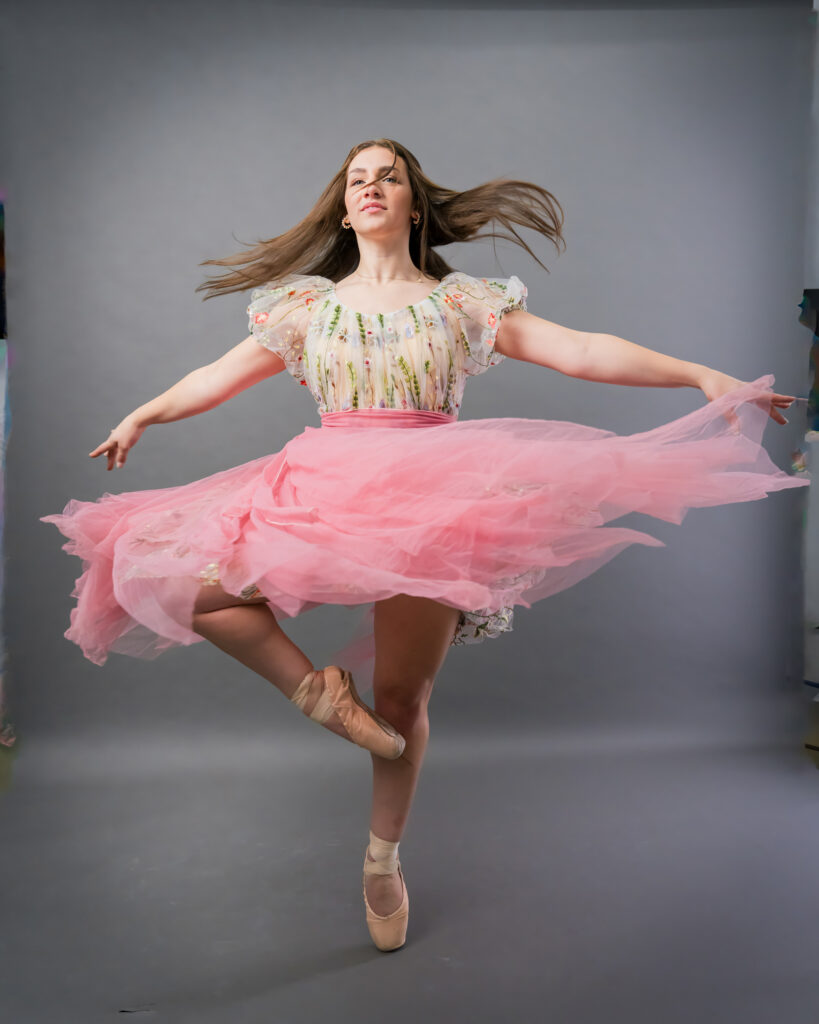 Dancer ballerina pointe shoes gray studio backdrop pirouette passé