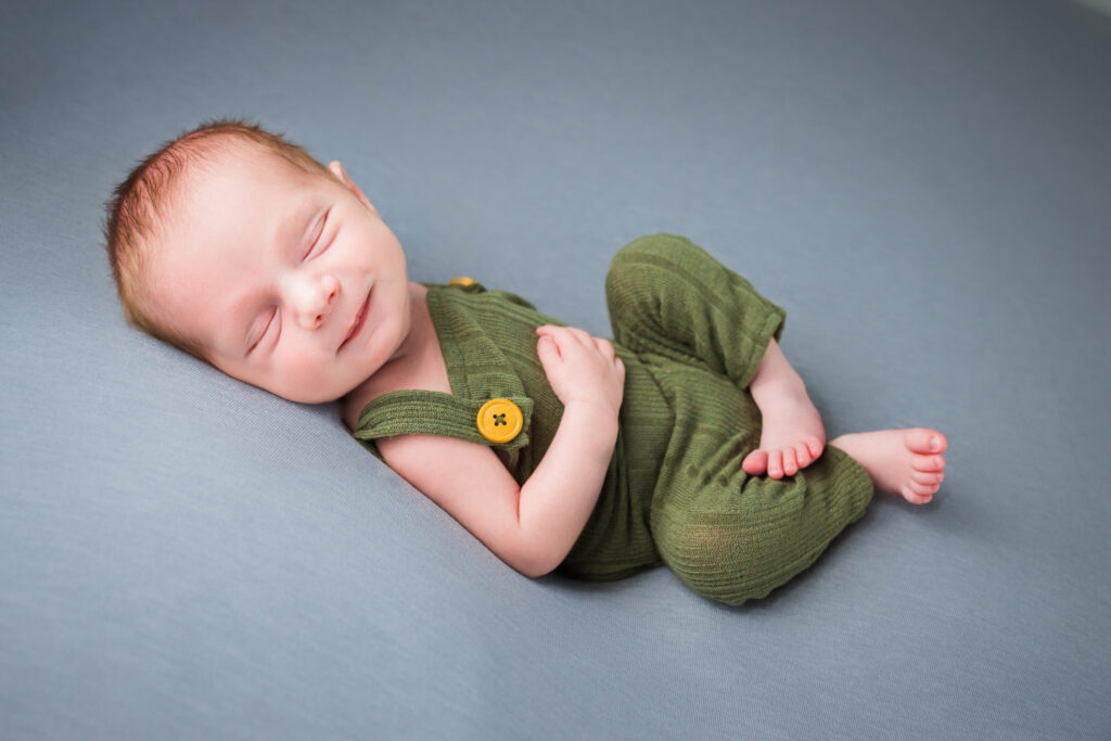 Baby boy a newborn gray studio overalls